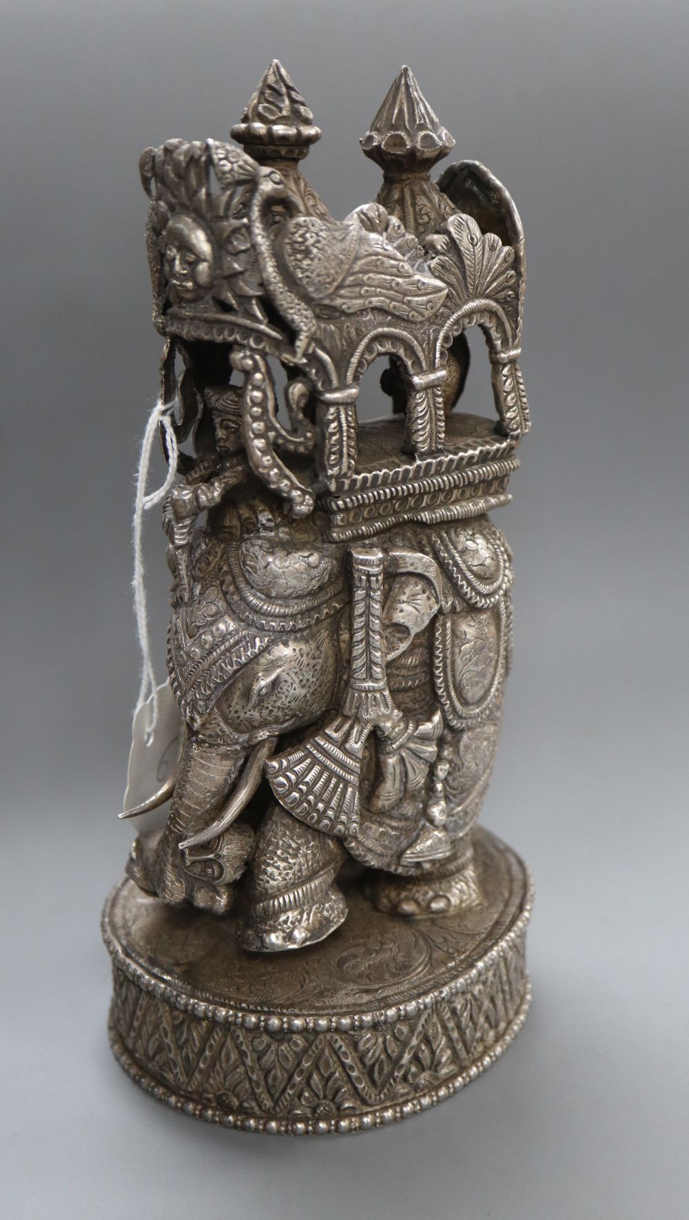 A 20th century Indian white metal model of an elephant with howdah and passengers, height 22.4cm, 18.5oz.